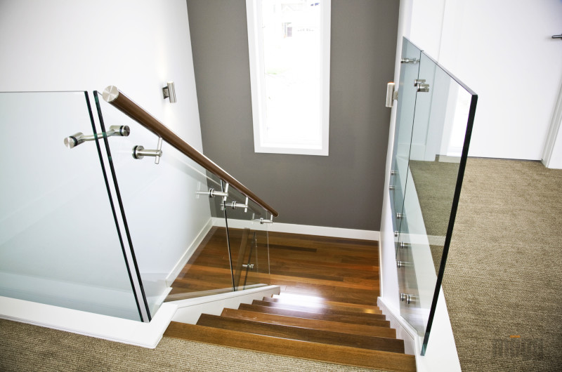 glass railing with wooden handrail and glass connectors